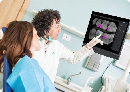 Pearl-Second Opinion-dentist with patient pointing at a caris 1